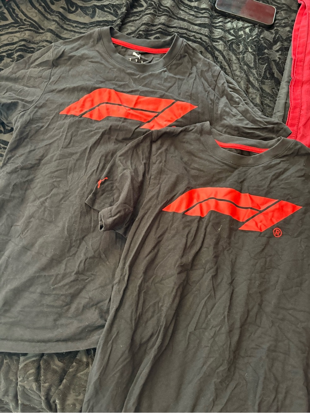 2 black unisex puma F1 shirts